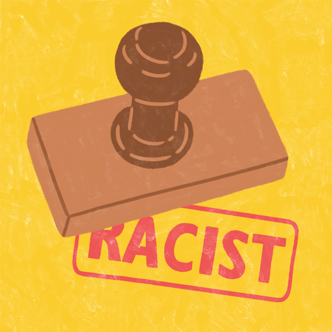 Brown wooden stamp labeling a yellow background with a red RACIST stamp