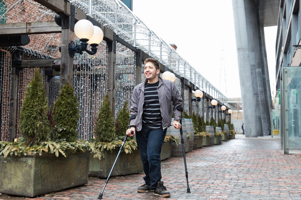 Image of a man walking with crutches