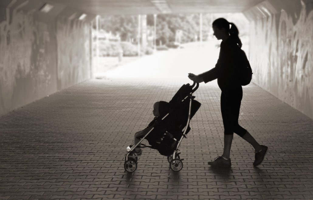 Image of a woman walking with her son in the city