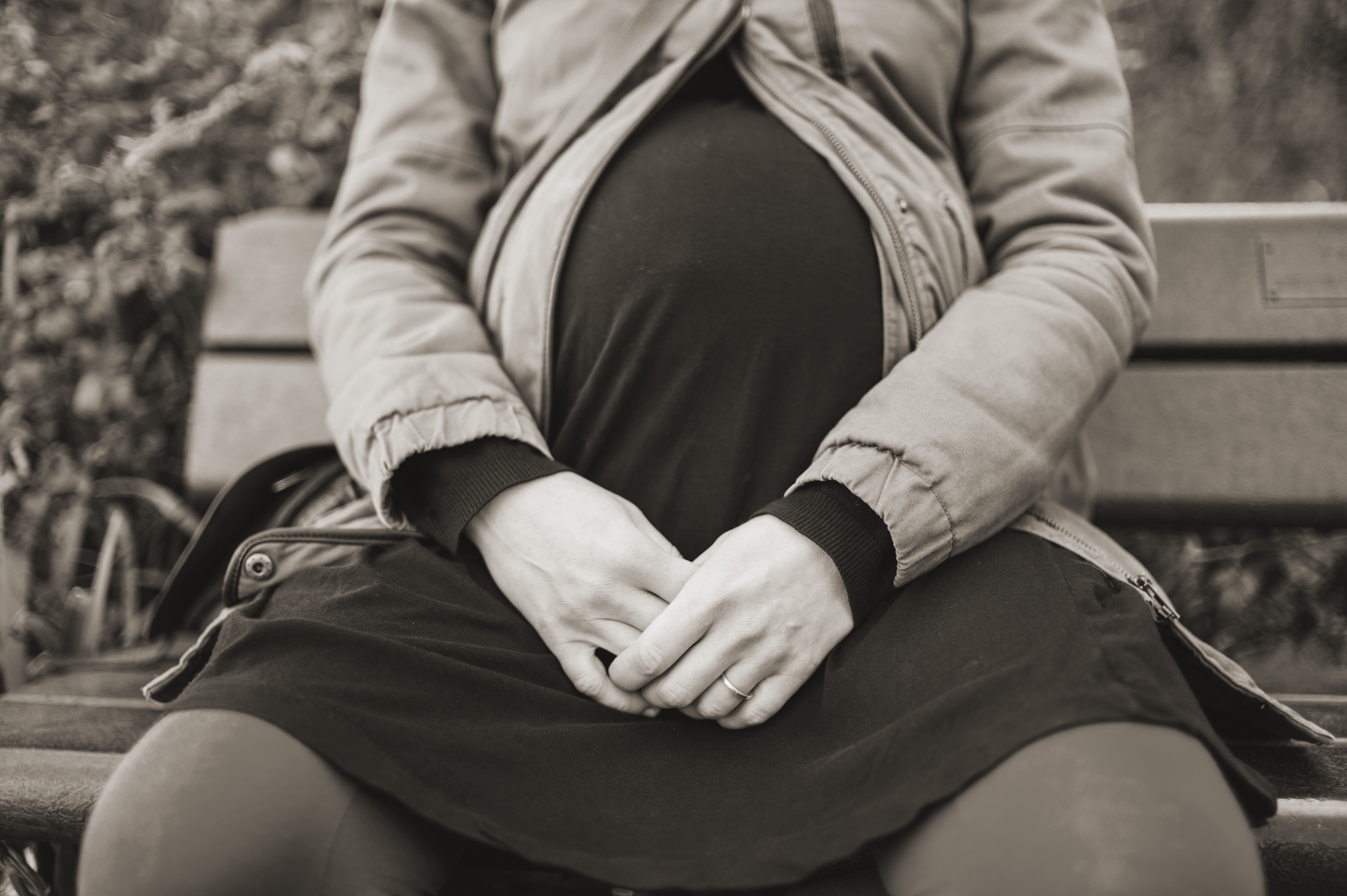 Photo of a pregnant woman sitting on a bench