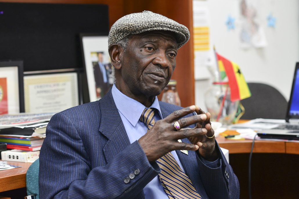 Photo of Winston LaRose sitting in a room with his hands pressed together