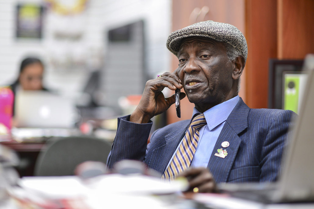 Photo of Winston LaRose, a.k.a. Mr. Jane and Finch, speaking on the phone