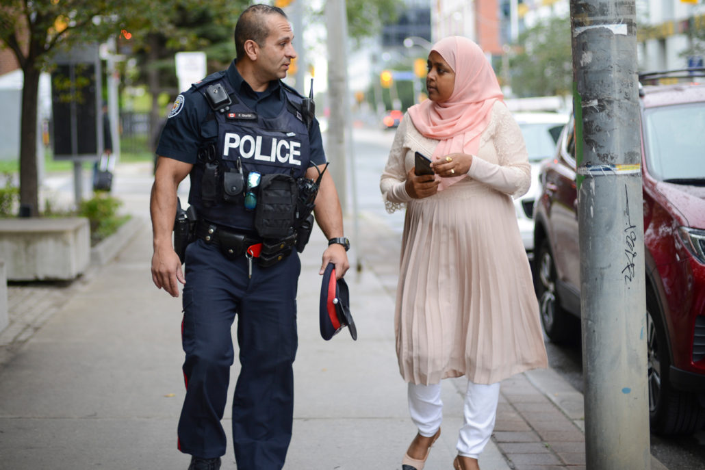 Sureya talking to a police officer