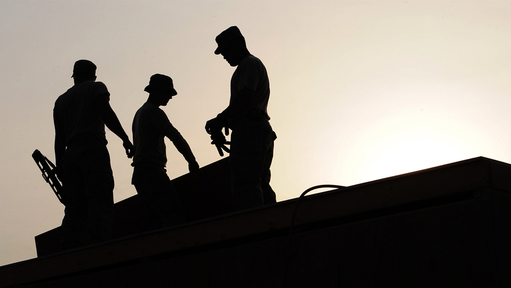 Silhouette three construction worker on site