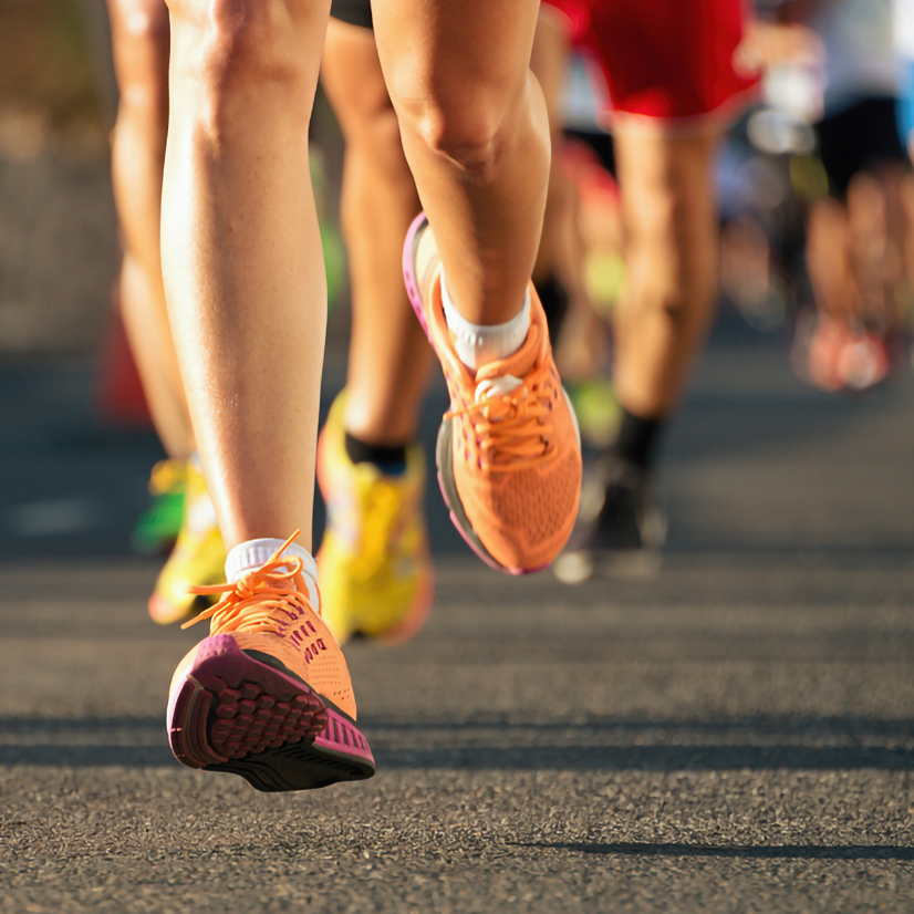 Marathon running race, people feet on city road.