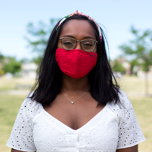 Varenya wearing a red face mask standing outdoors