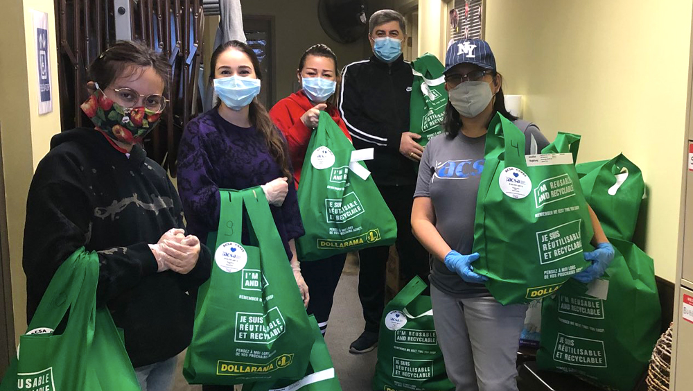 A team of agency employees and volunteers work together distributing donations.