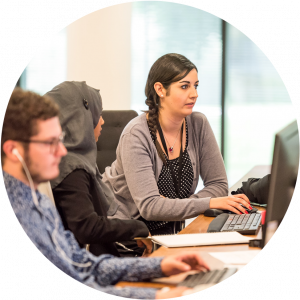 Group of adult students attending computer course