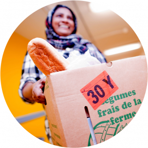 A Muslim woman carrying a food box