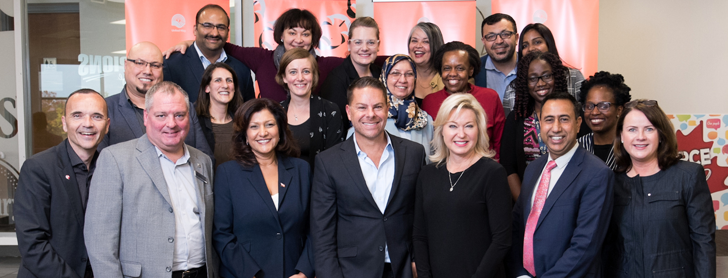 A group of people from General Mills and United Way, also Mayor of Mississauga pose for a picture together.