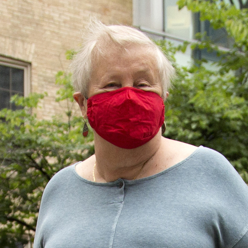 A senior women wearing a red mask