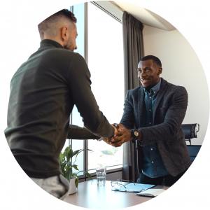 Two people shaking hands during meeting in a office