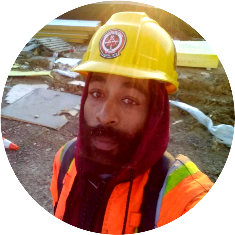 A young man in workwear standing in construction site