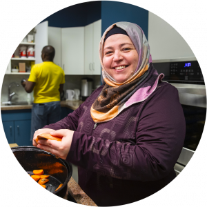 Woman in hijab working in community kitchen.