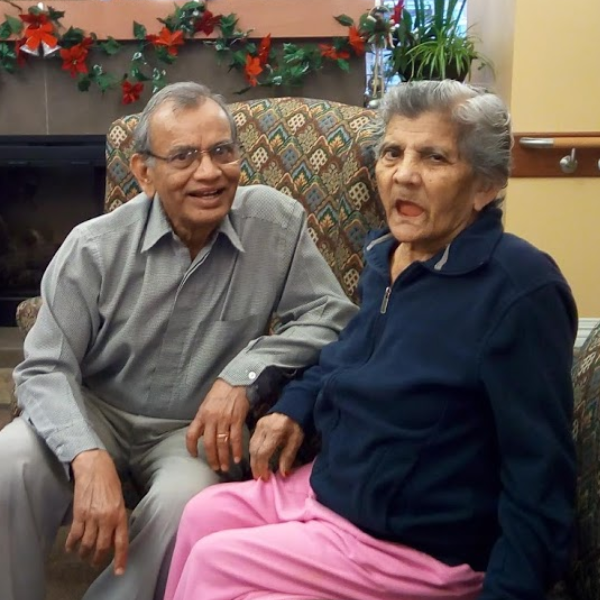 Premji and his wife Shanta sitting in room.