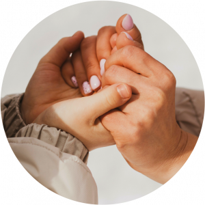 Closeup shot of two women holding hands in comfort