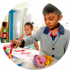 Two children painting at a table