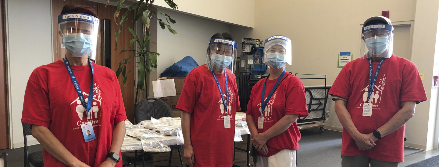 Four community ambassadors wearing face shield and mask at a clinic.