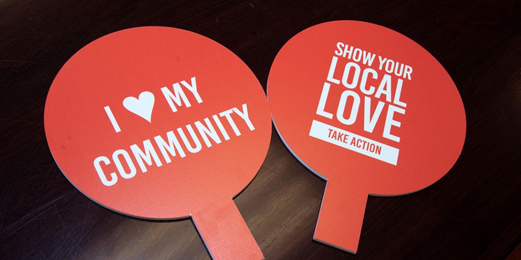 Two photo props that read: 'Show your Local Love' and 'I love my community'