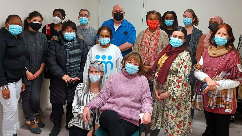 Group photo of masked staff from TNG
