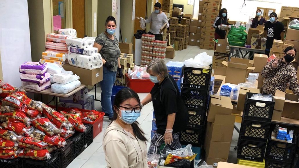 Staff at Agincourt Community Services Association pack food boxes.