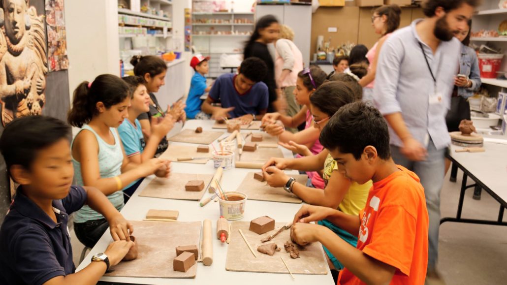 Photo of a group of kids doing a creative activity as part of ACSA’s programming