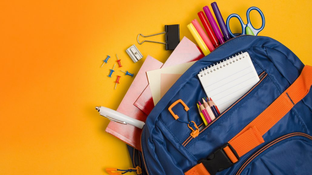 Photo of a child’s backpack filled with school supplies