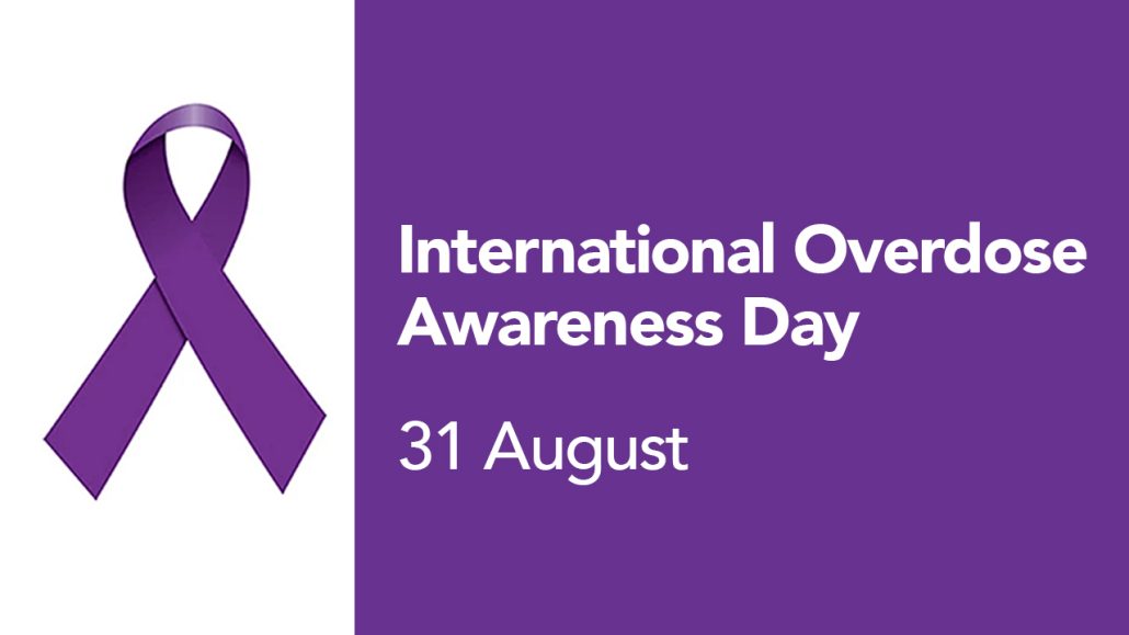 A banner with a purple ribbon that reads 'International Overdose Awareness Day'