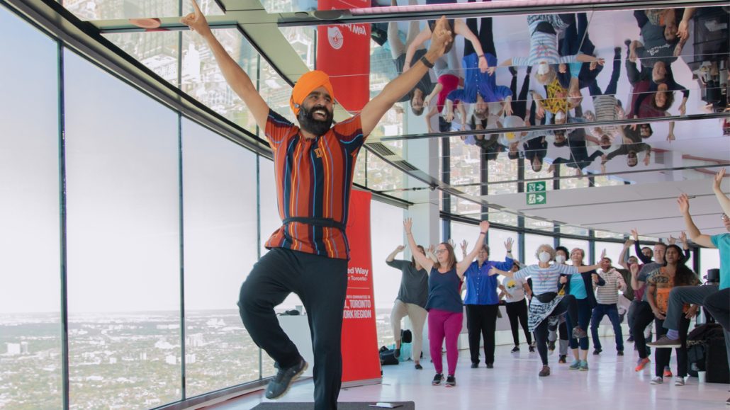 Gurdeep Pandher leading a Bhangra dance at the top of the CN Tower.