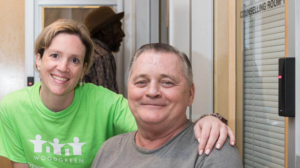 Photo of two people in front of a door for the counselling centre at WoodGreen Community Services