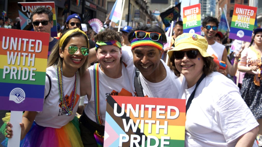 A group of United Way employees pose together at the Toronto Pride Parade.
