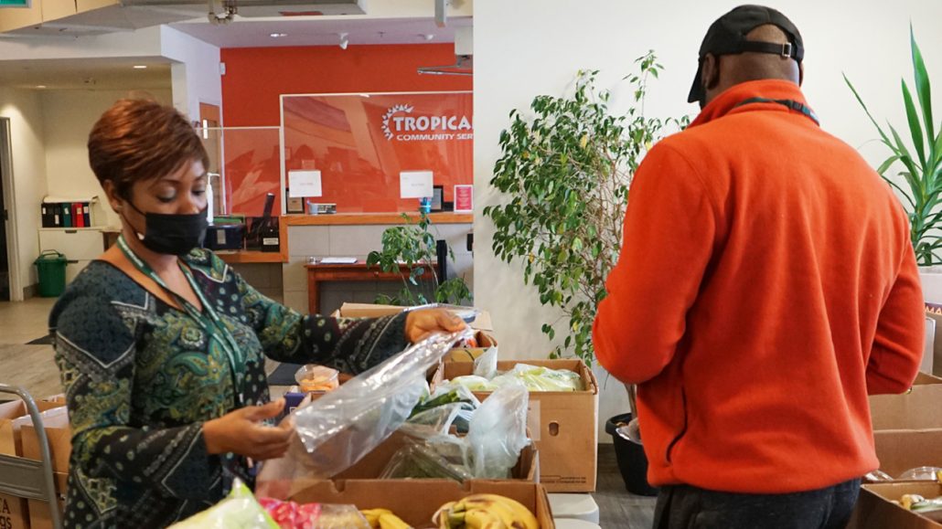 Volunteers are checking and organizing food baskets for pick up and delivery.