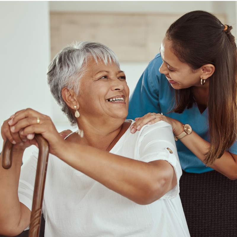 Senior woman being helped by attendent.