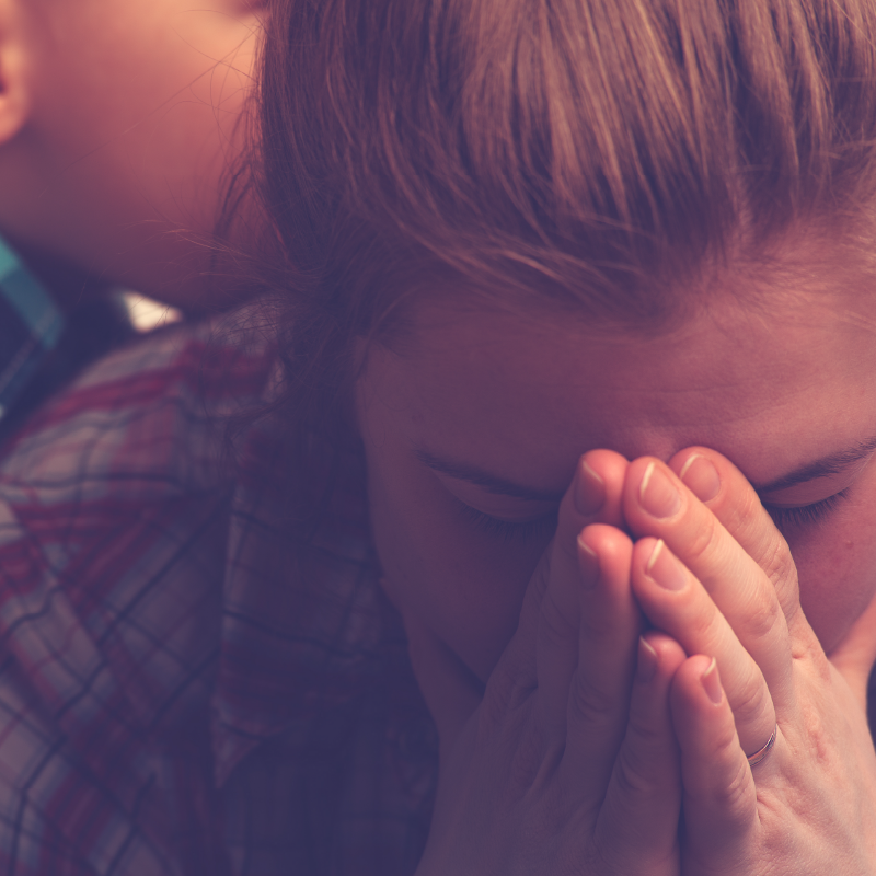 Upset woman with hands folded.