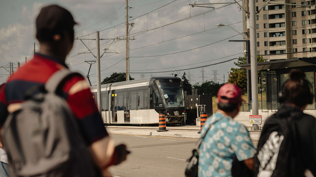 Photo of a several people looking at an LRT train.