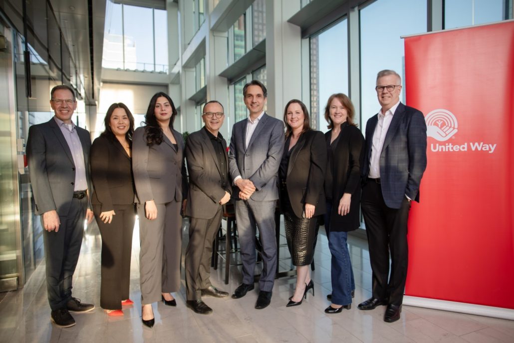 Members of the United Way standing with the senior executive team of EY.