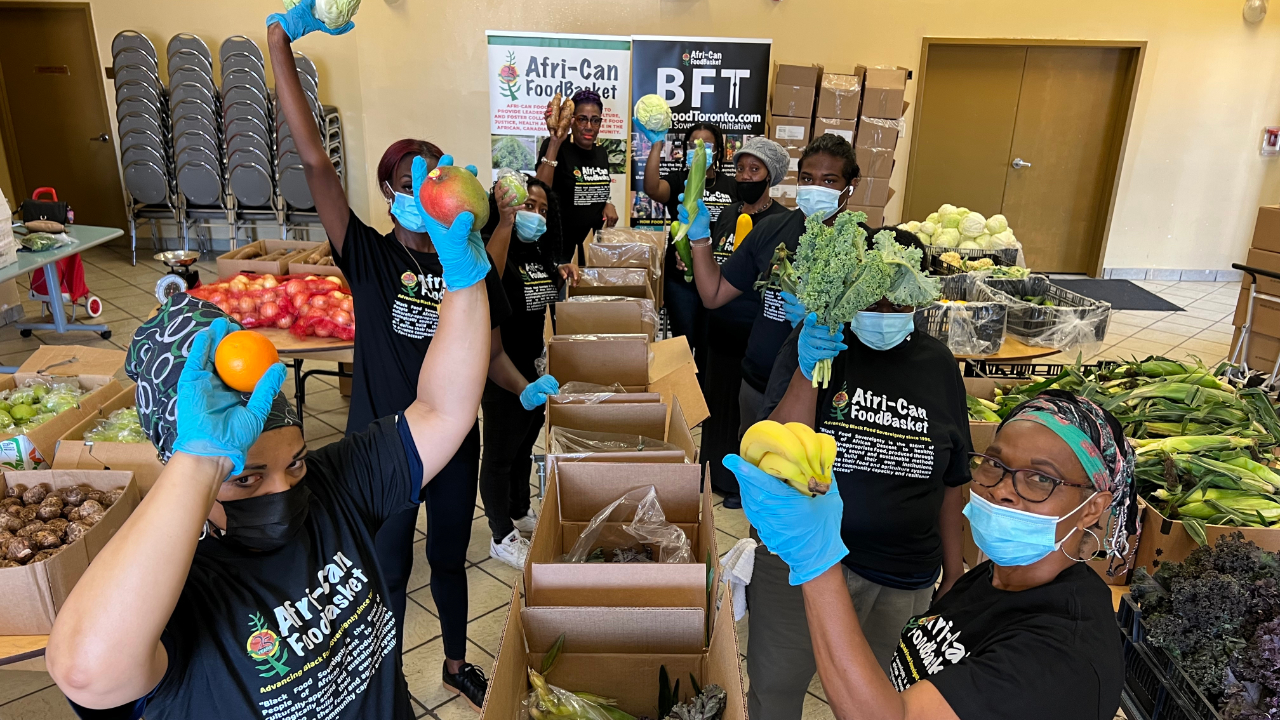 Volunteers packing boxes at the African Food Basket.