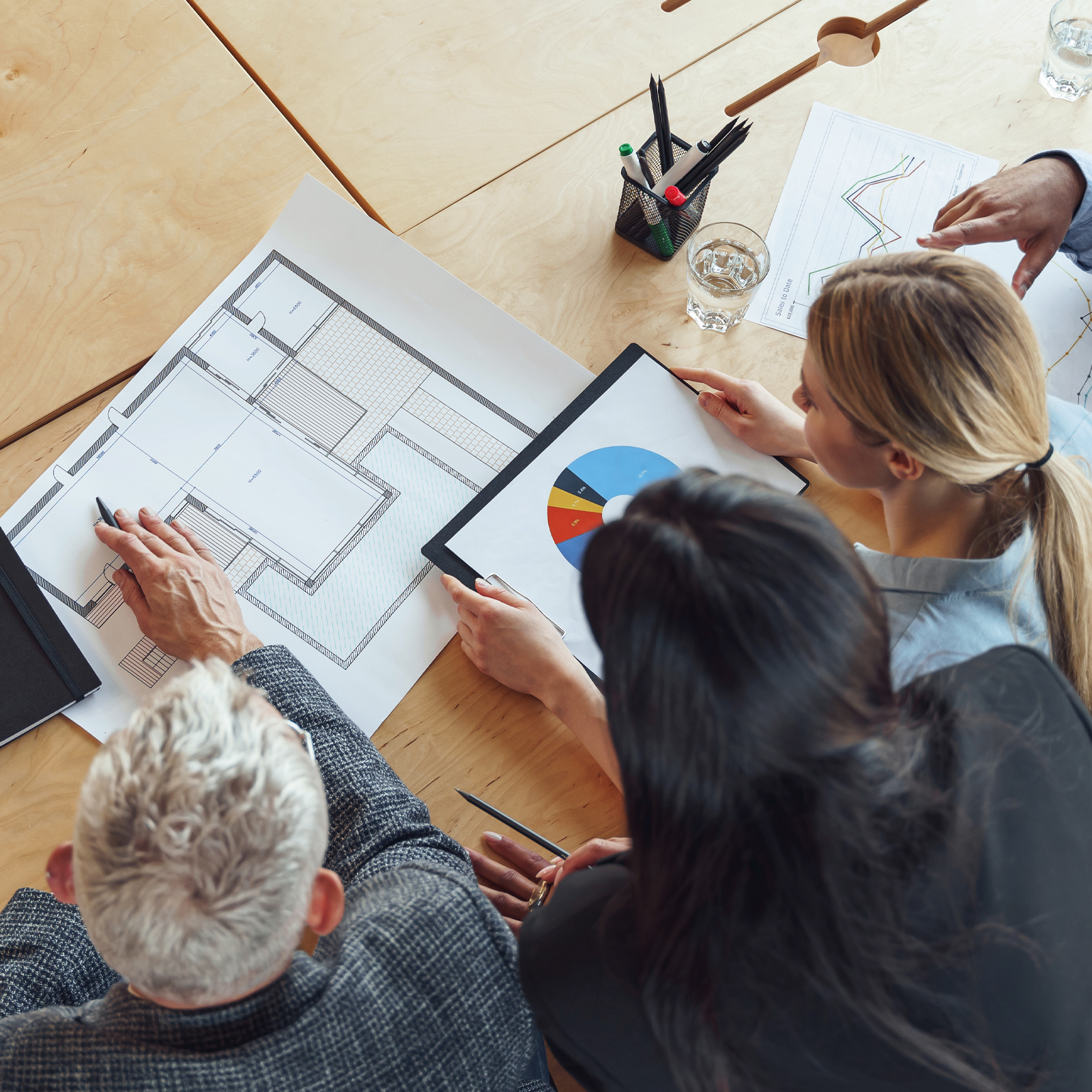 People looking at blueprints