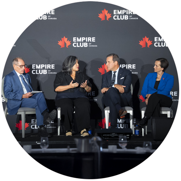 Four people sit on a stage in front of a backdrop that has the “Empire Club of Canada” logo on it. From left to right are Giles Gherson, President and Chief Executive Officer of the Toronto Region Board of Trade, Ana Serrano, President of OCAD University, Jordan Bitove, Publisher of the Toronto Star, and Heather McDonald, President & CEO of United Way Greater Toronto.