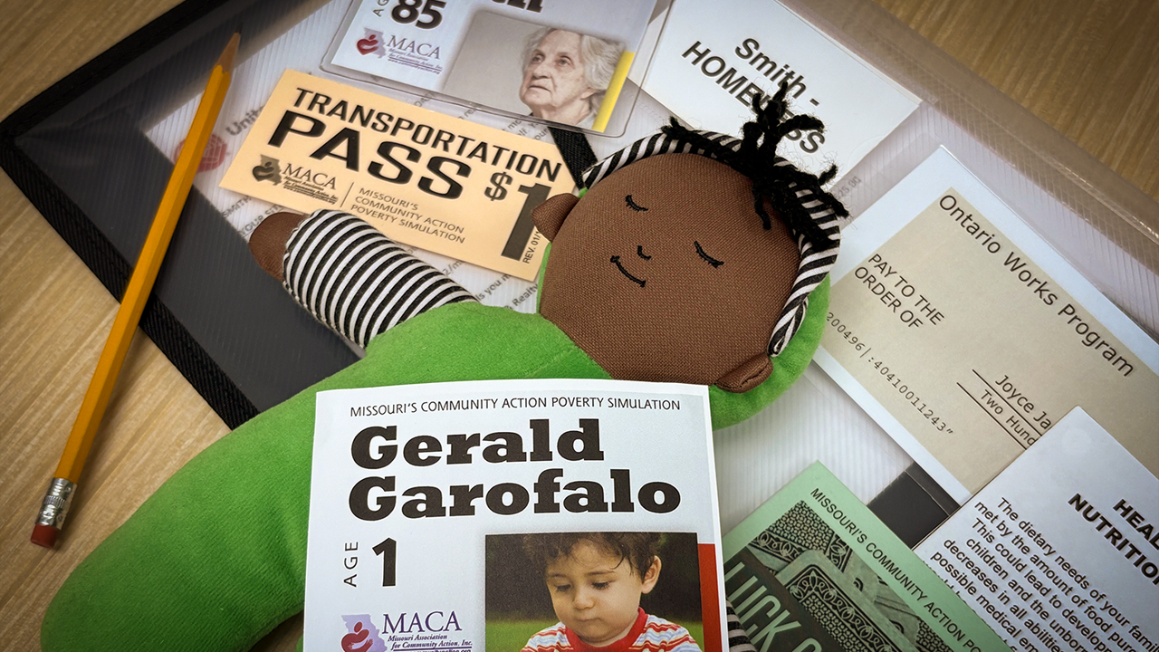 Supplies for a poverty simulator, including a participant profile sheet, a transit pass, and a small doll.