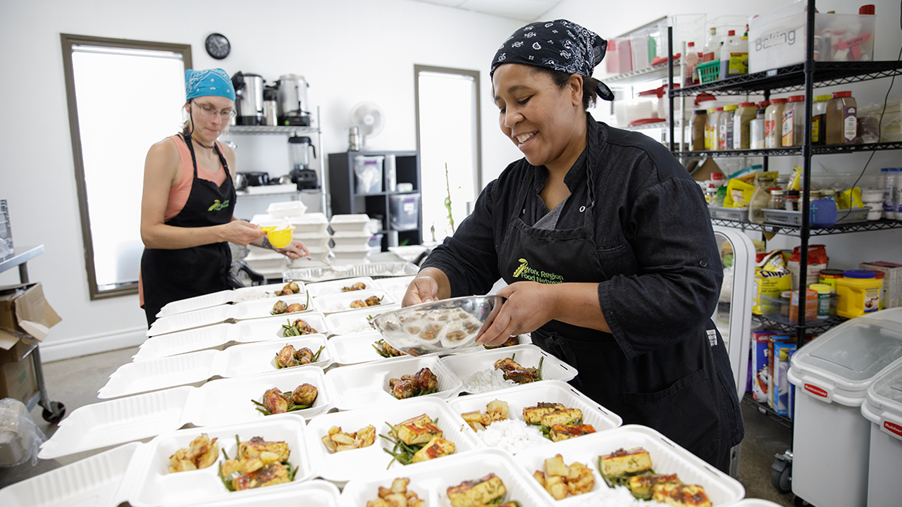 Two women at York Region Food Network package food for community distribution.