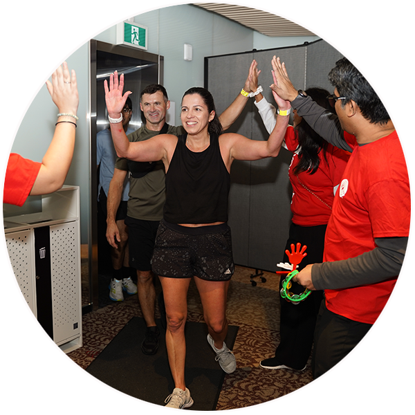 People dressed in athletic clothes give high fives to volunteers after climbing the steps of the CN Tower at United Way ClimbUP.