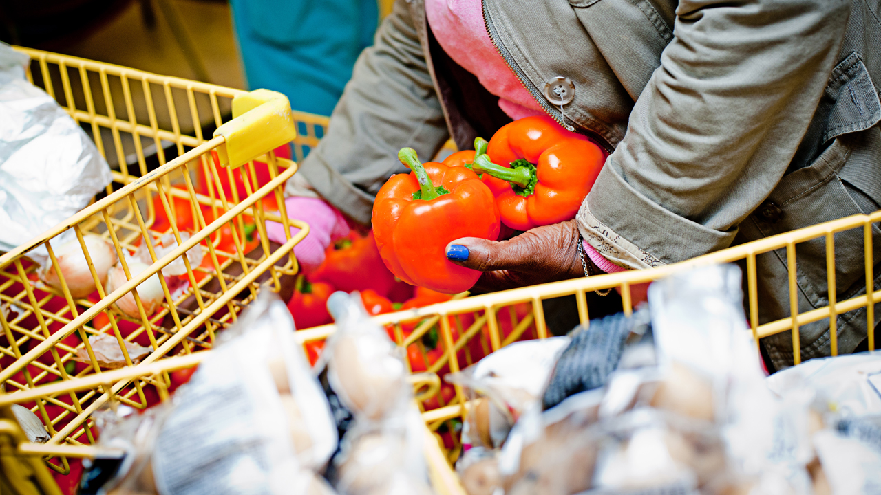 Woman-holding-red-peppers-at-grocery-store