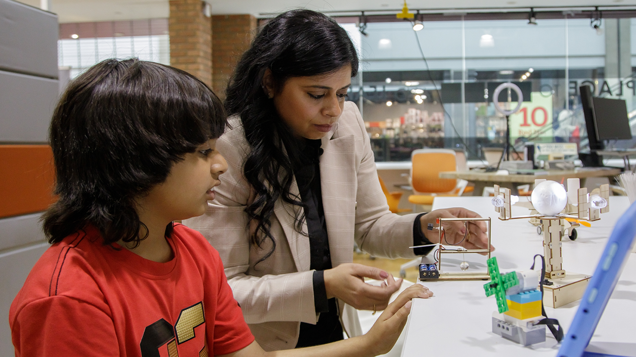 Rakhee works with her son on a DIY STEM kit.