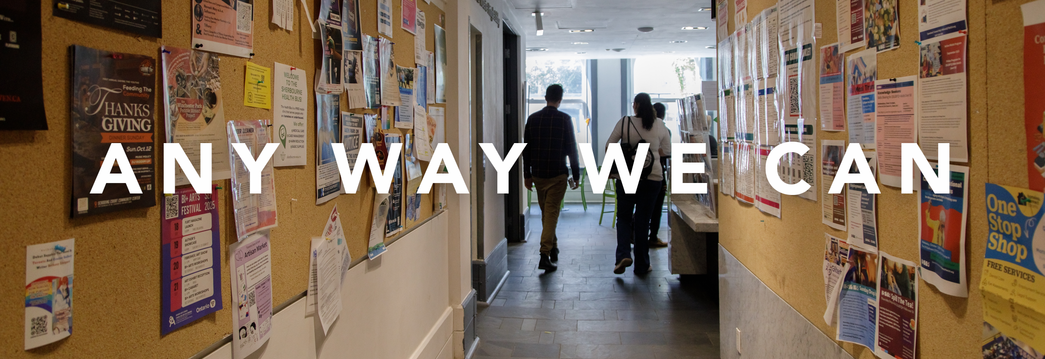 People walk down a hallway lined with bulletin boards at the United Way-funded agency The 519. White text over the image reads: “Any way we can.”