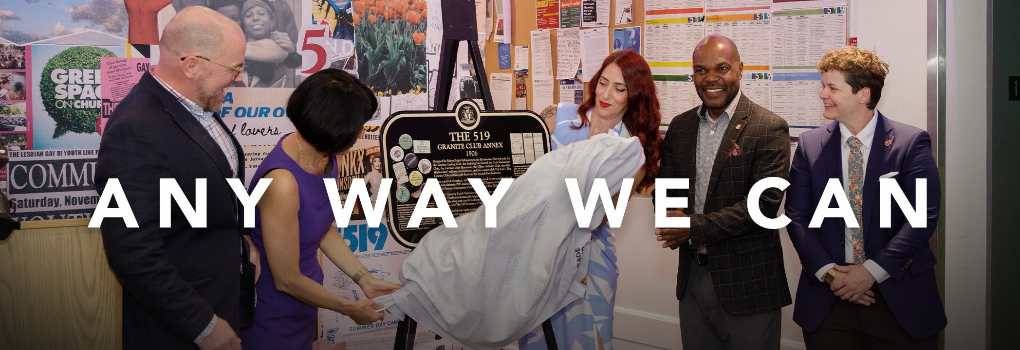 People stand, smiling while unveiling the plaque at the United Way-funded agency The 519. White text over the image reads: “Any way we can.”