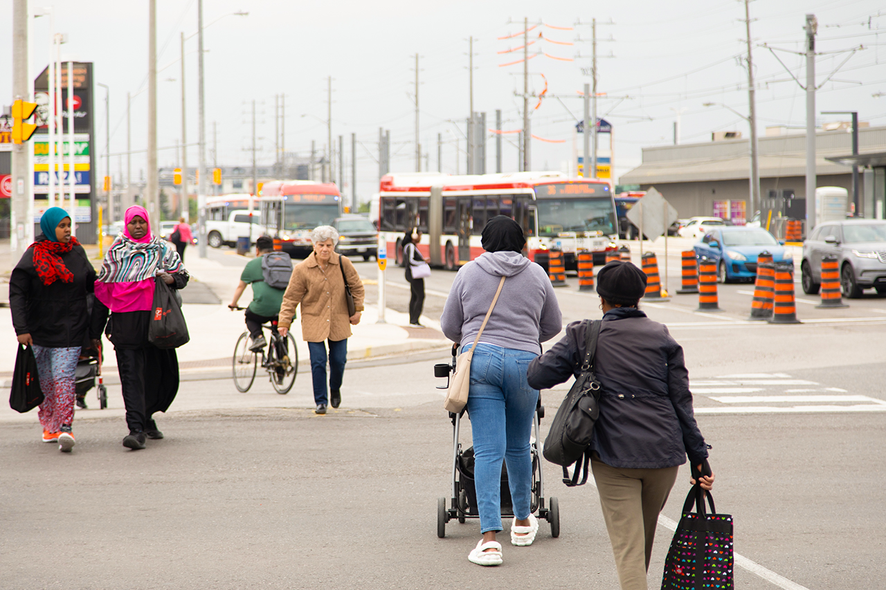 People walk across a busy intersection in the Jane and Finch neighbourhood.