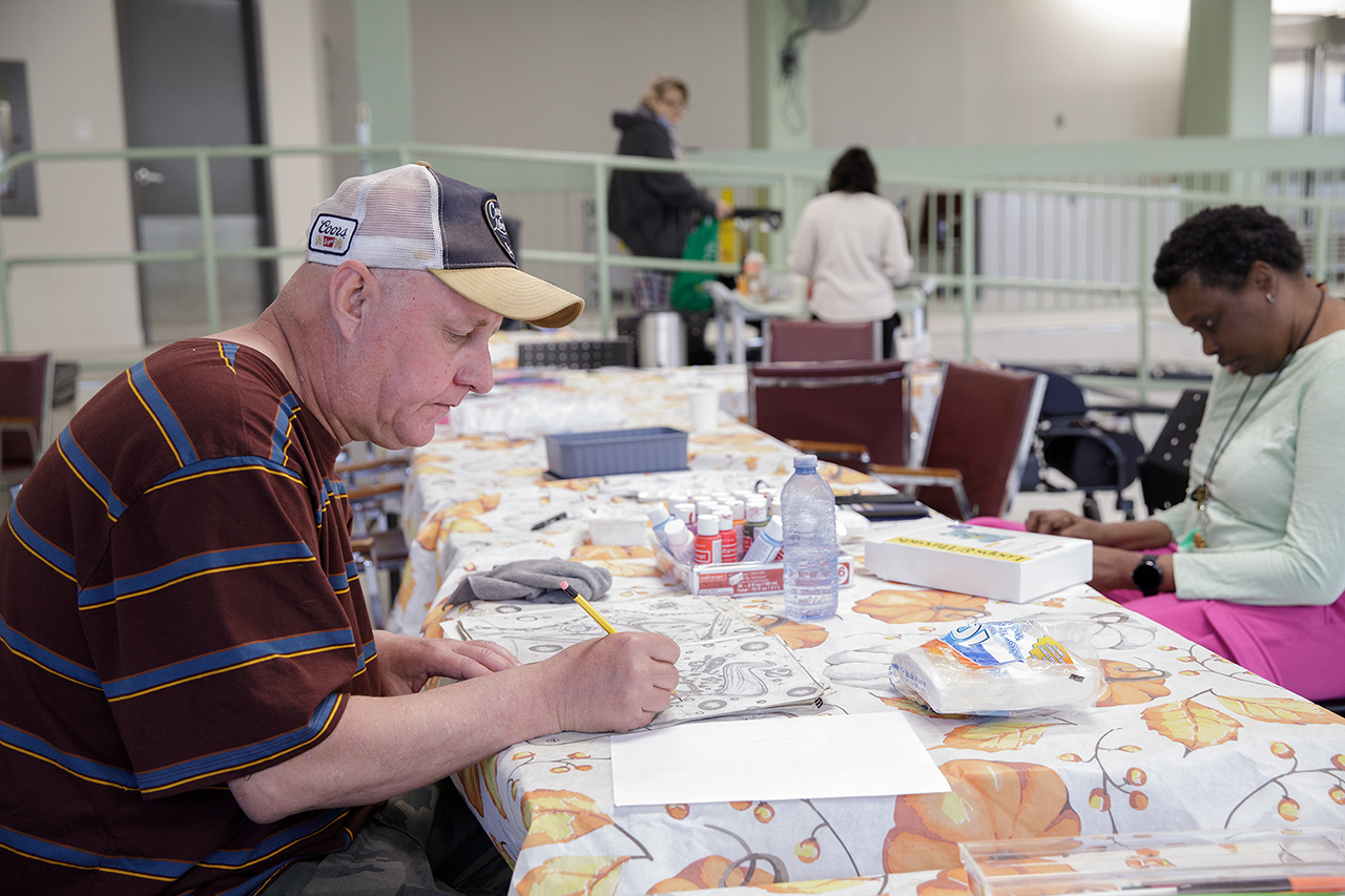 Ted and other program participants draw at the table