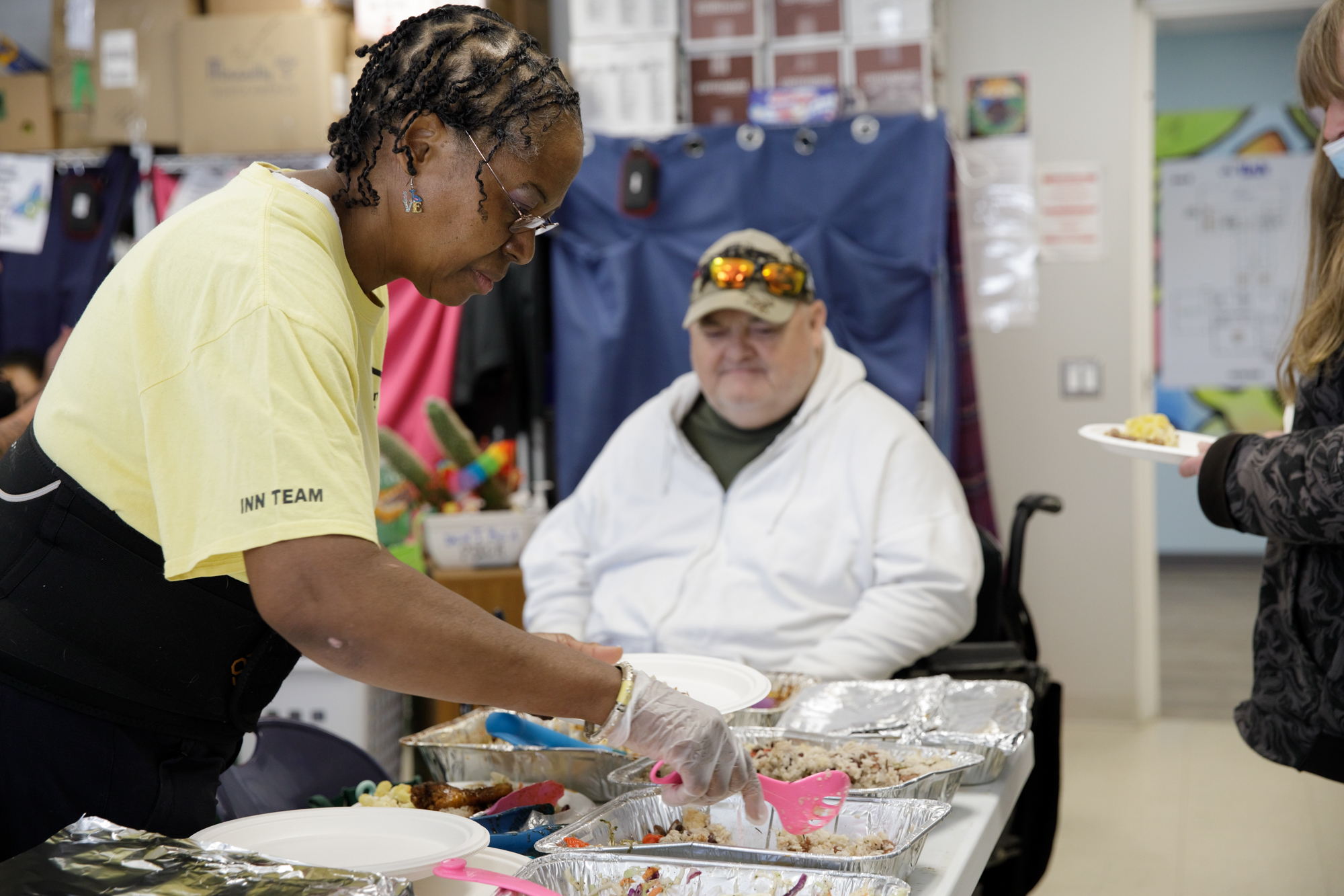 Carleen serves food during a celebration for participants graduating from the eight-week Getting Ahead program.