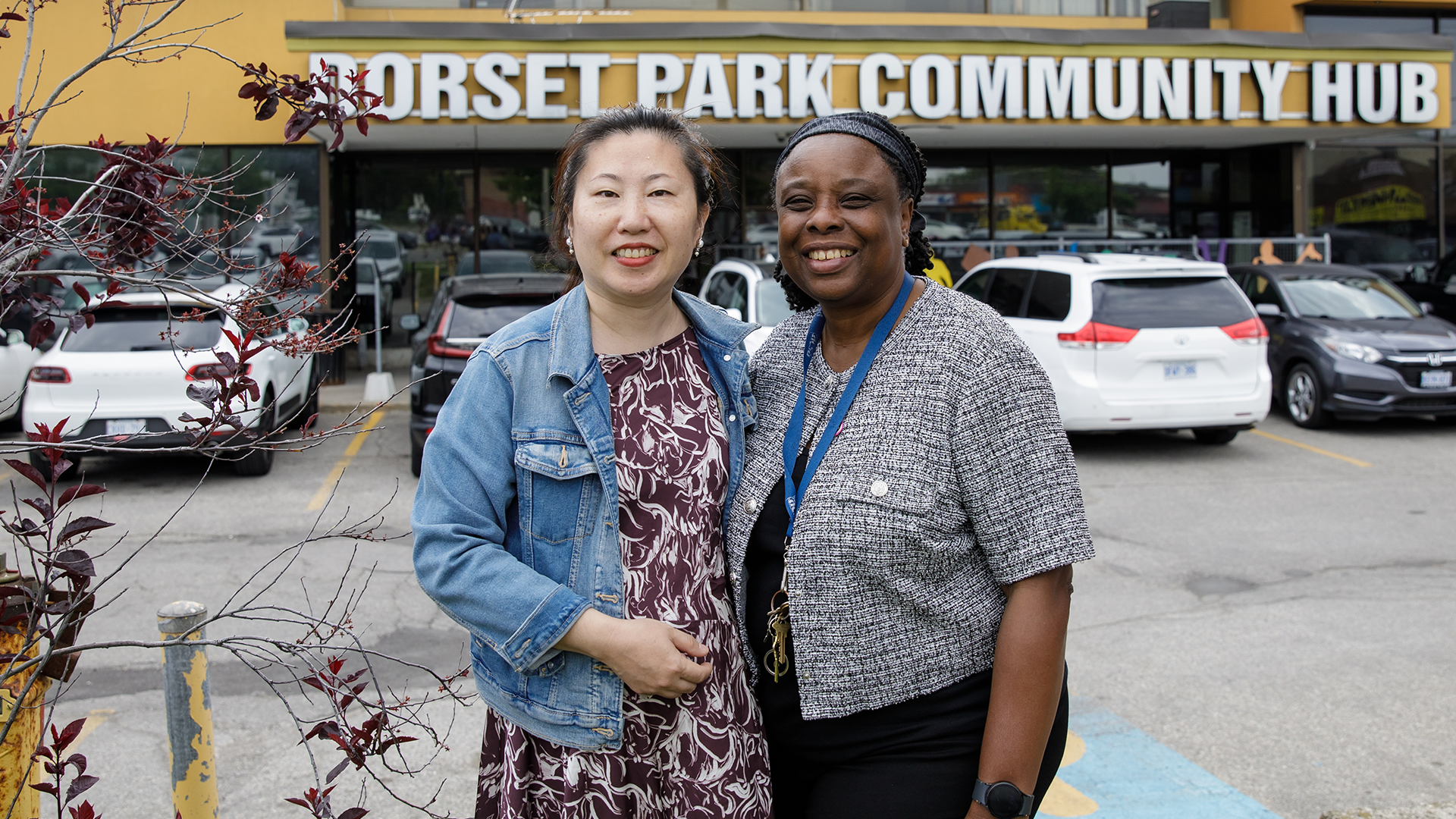 Emily, left, stands with Dorset Park Community Hub Manager Yvette outside the Dorset Park Community Hub in Scarborough, Ontario.